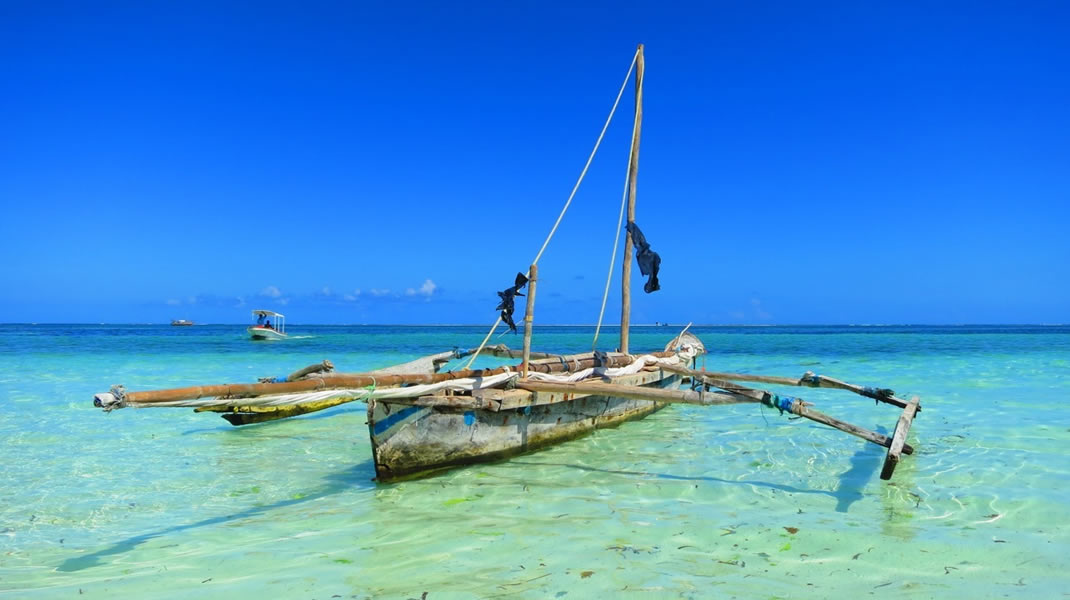 Traditional boat in the clear tropical waters around Funzi Island Kenya